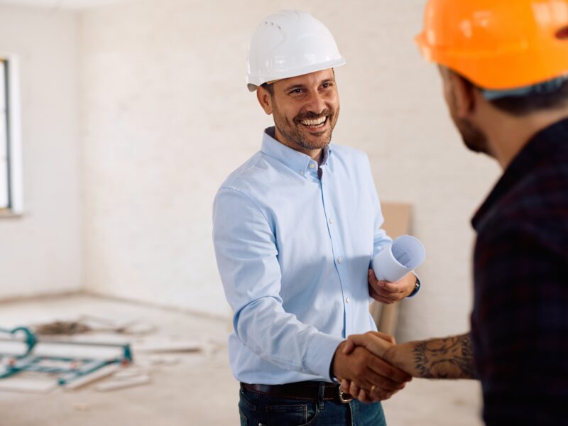 Happy,Building,Contractor,Shaking,Hands,With,A,Worker,At,Construction